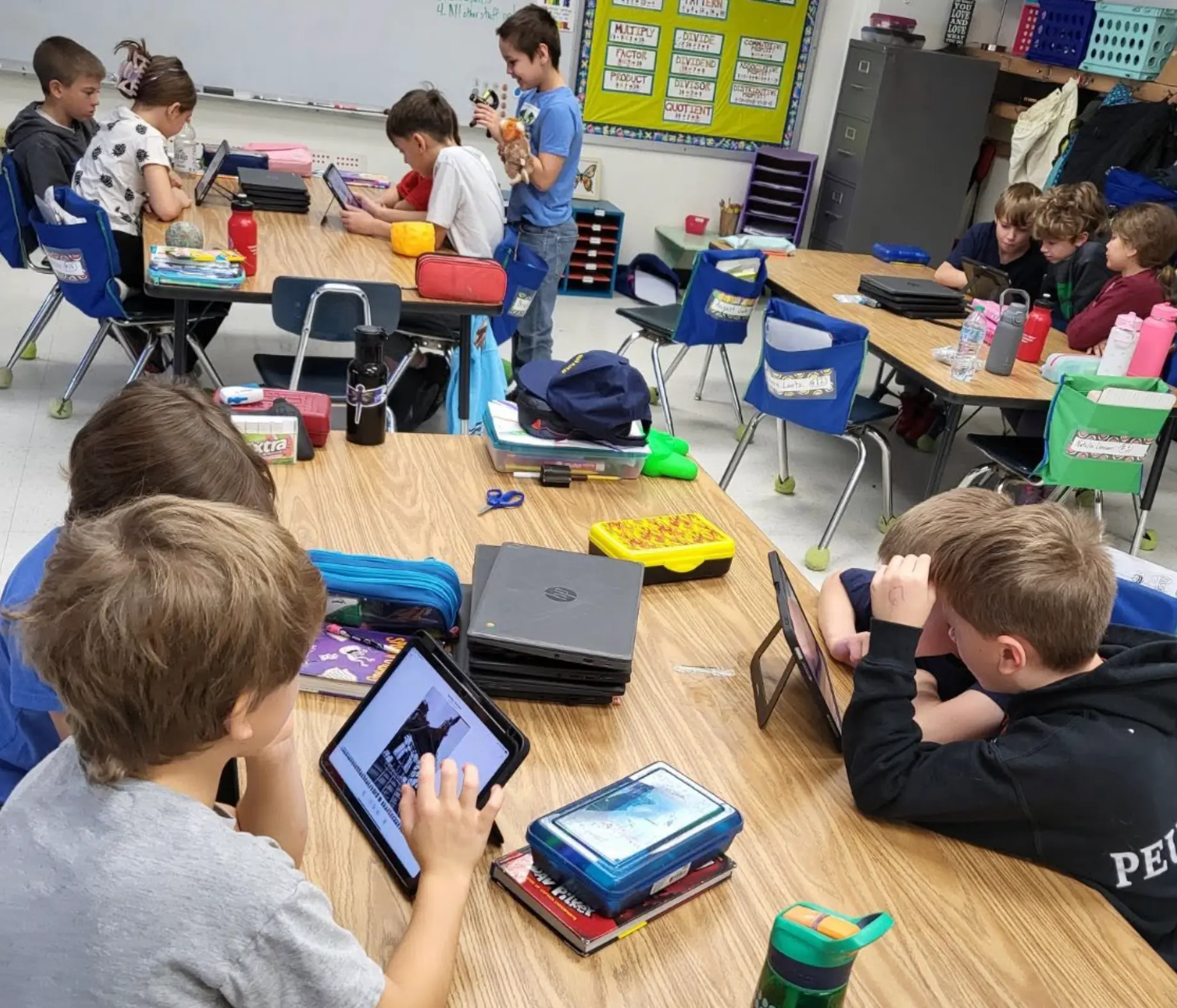Students working with 3D shipwreck models on tablets